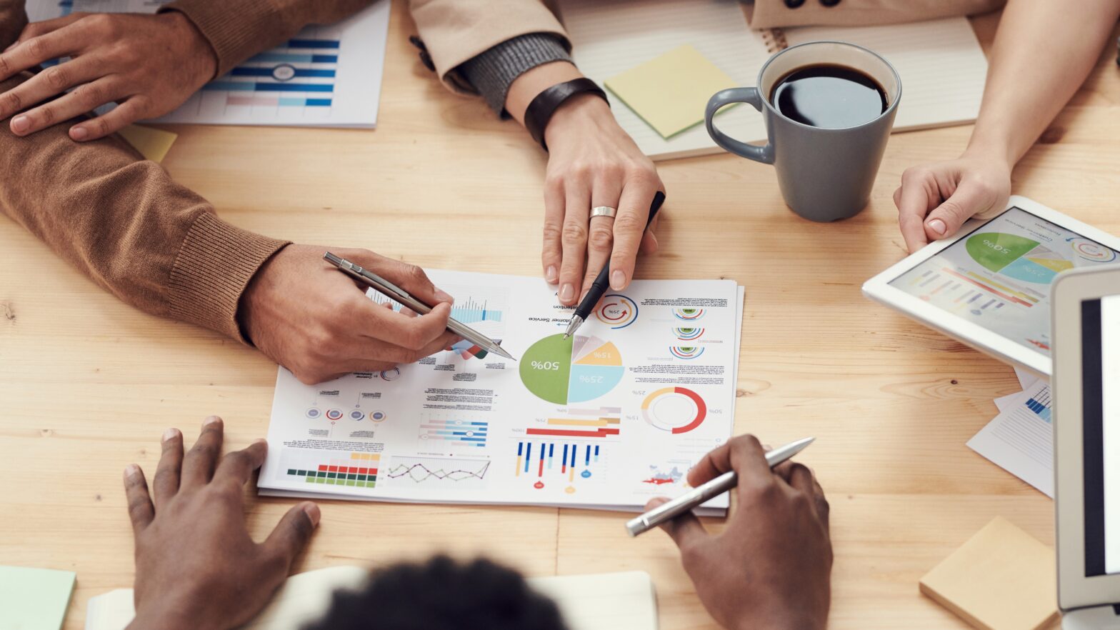 A group of people developing a comprehensive marketing strategy by examining graphs.