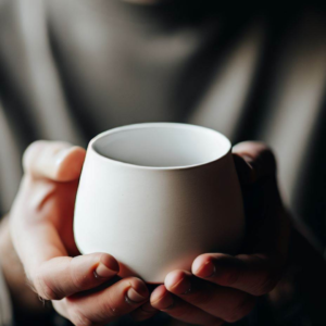 A man holding a white cup, implementing digital marketing services for restaurants.