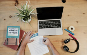 A person is using a laptop at a desk.