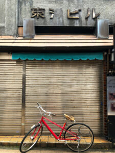 A red bicycle parked in front of a building, enhancing local SEO for small businesses in Portland Metro.